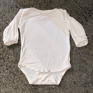Kate Quinn neutral cream onesie